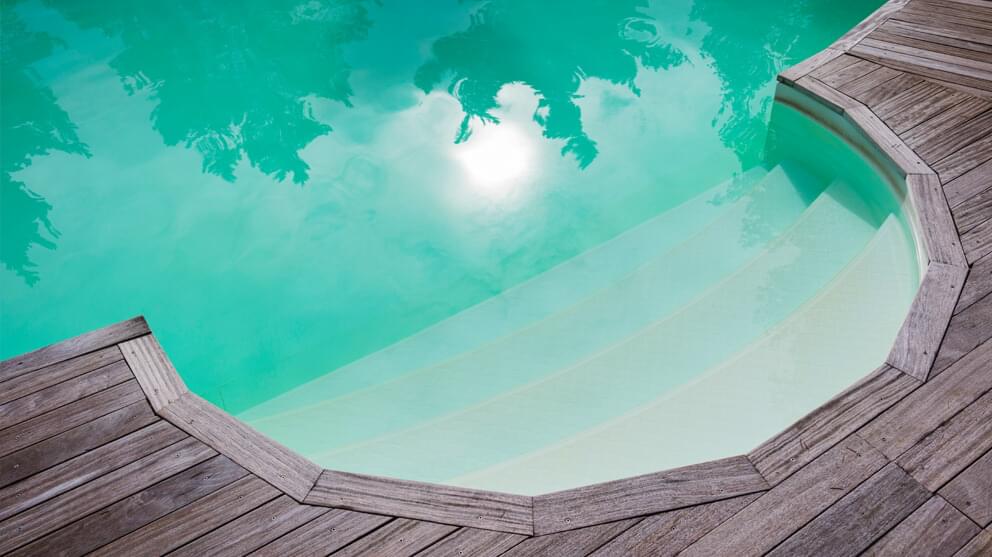 Reflection of sun over swimming pool with steps