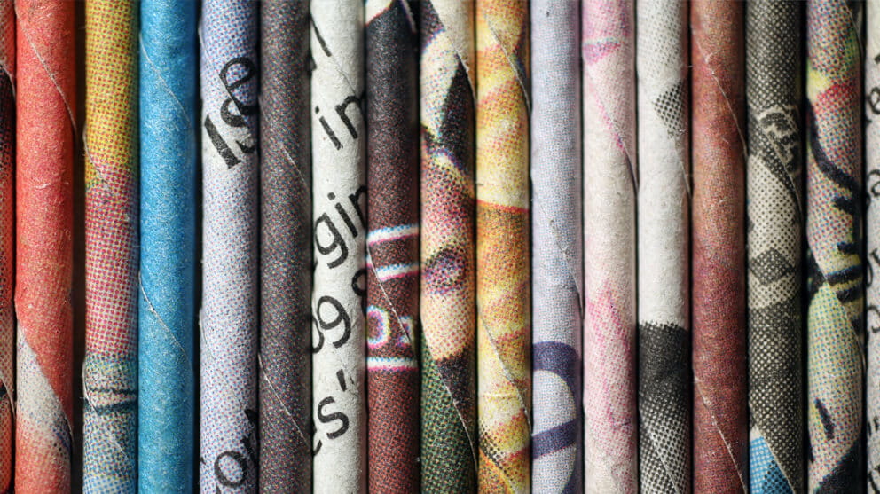 Rolled newspaper pages