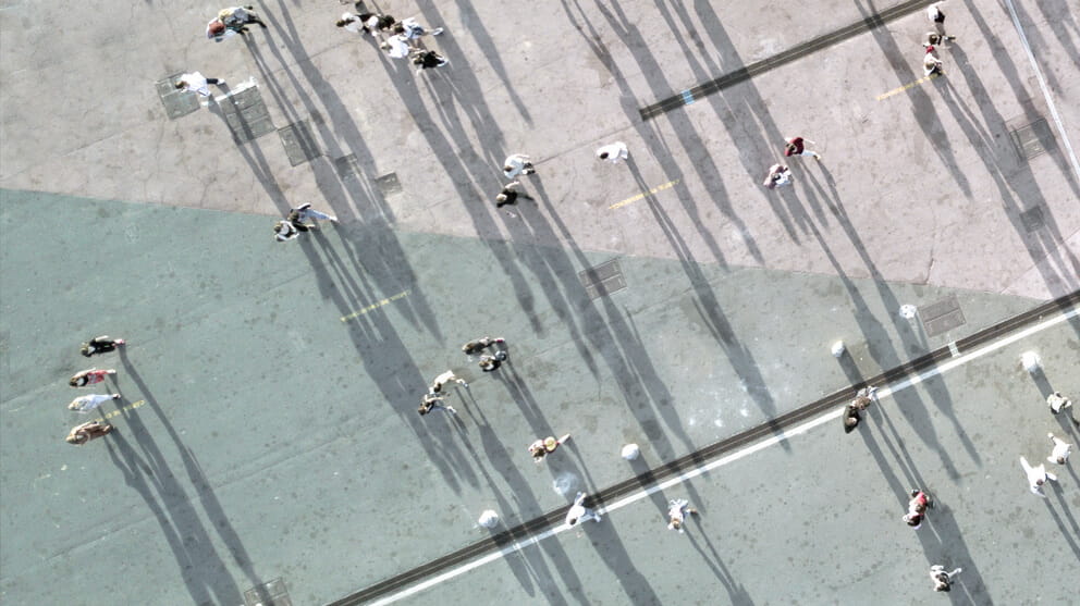 Looking down over people with long shadows