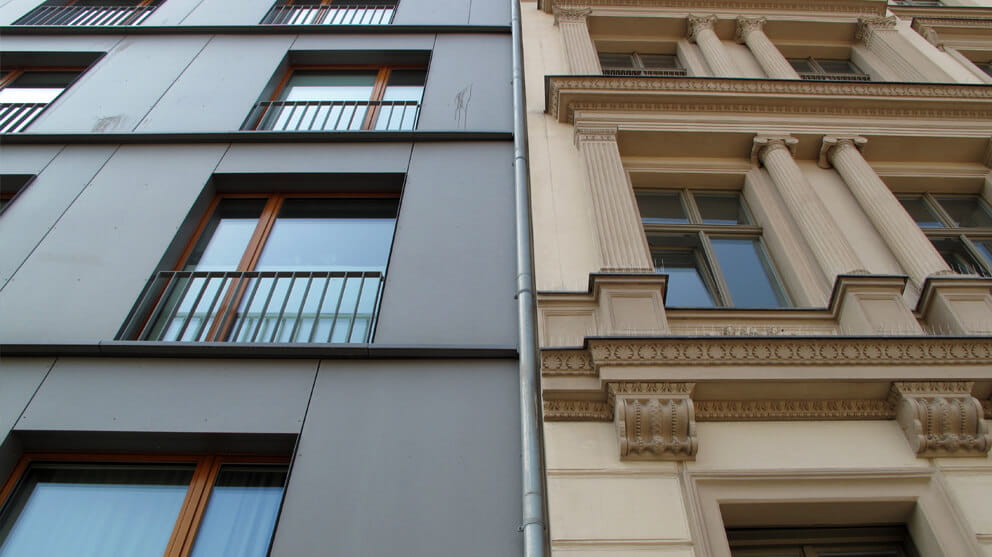 Contrast between modern and ornate old facade residential building